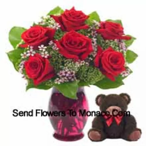 7 Red Roses With Some Ferns In A Glass Vase Along With A Cute 14 Inches Tall Teddy Bear