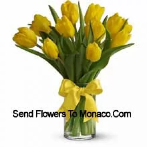 Yellow Tulips With Seasonal Fillers And Leaves In A Glass Vase - Please Note That In Case Of Non-Availability Of Certain Seasonal Flowers The Same Will Be Substituted With Other Flowers Of Same Value