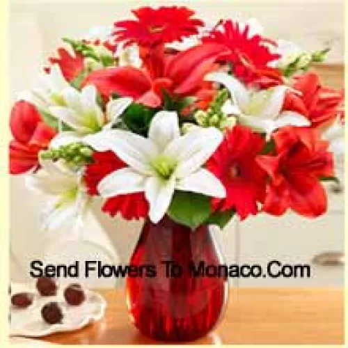 Red Gerberas, White Lilies, Red Lilies And Other Assorted Flowers Arranged Beautifully In A Glass Vase