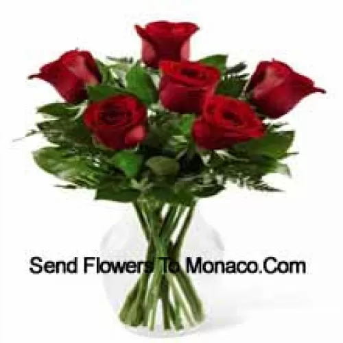 7 Red Roses With Some Ferns In A Glass Vase