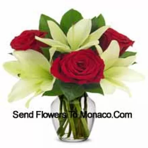 Red Roses And White Lilies With Seasonal Fillers In A Glass Vase