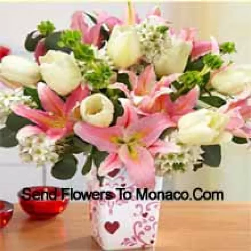 Pink Lilies And White Tulips With Assorted White Fillers In A Glass Vase - Please Note That In Case Of Non-Availability Of Certain Seasonal Flowers The Same Will Be Substituted With Other Flowers Of Same Value