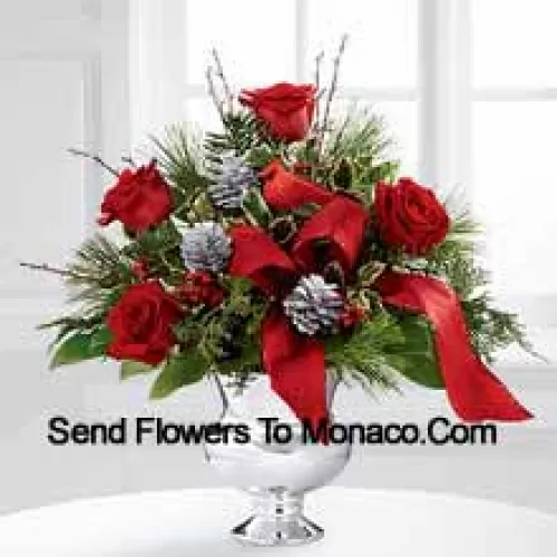 Highly elegant and bursting with your merriest wishes, this bouquet will create the perfect holiday gift. Rich red roses are vibrant and bright arranged with variegated holly, assorted holiday greens, silver pinecones and branches, all perfectly accented with a faux cardinal and designer red ribbon. Presented in a silver pedestal vase, this bouquet will add to the joy and festivities of their holiday season with each gorgeous bloom. (Please Note That We Reserve The Right To Substitute Any Product With A Suitable Product Of Equal Value In Case Of Non-Availability Of A Certain Product)