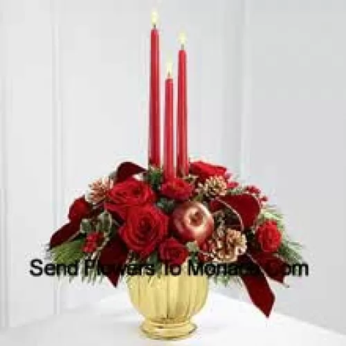 The grandeur and rich beauty of the Christmas season are highlighted with each crimson bloom. Bright red roses and spray roses are arranged in a designer gold container amongst variegated holly and assorted holiday greens. Accented with artificial apples, gold pinecones and gold-edged burgundy ribbon, this gorgeous centerpiece displays three red taper candles to create the perfect atmosphere for their holiday celebration.? (Please Note That We Reserve The Right To Substitute Any Product With A Suitable Product Of Equal Value In Case Of Non-Availability Of A Certain Product)